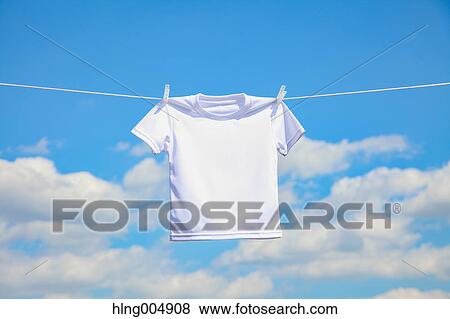Stock Photo - Laundry hanging against blue sky. Fotosearch
