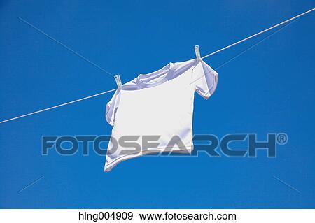 Laundry hanging against blue sky View Large Photo Image Stock Photo - Laundry hanging against blue sky. Fotosearch