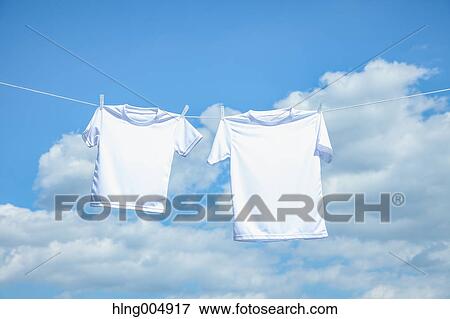 Laundry hanging against blue sky View Large Photo Image Stock Photo - Laundry hanging against blue sky. Fotosearch