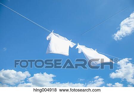 Laundry hanging against blue sky View Large Photo Image Stock Photo - Laundry hanging against blue sky. Fotosearch