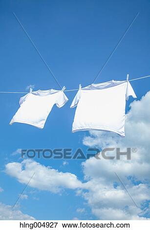 Stock Photo - Laundry hanging against blue sky. Fotosearch