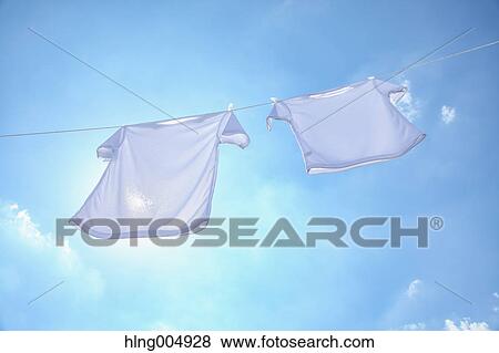 Laundry hanging against blue sky View Large Photo Image Stock Photo - Laundry hanging against blue sky. Fotosearch