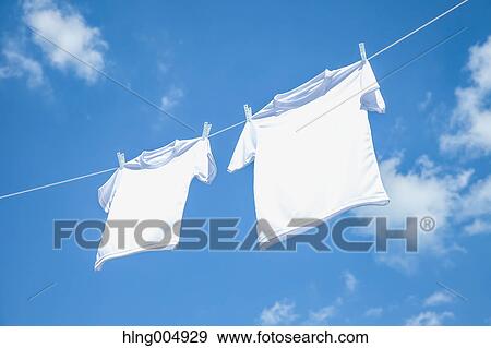 Laundry hanging against blue sky View Large Photo Image Stock Photo - Laundry hanging against blue sky. Fotosearch