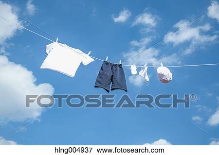 Laundry hanging against blue sky View Large Photo Image Stock Photo - Laundry hanging against blue sky. Fotosearch