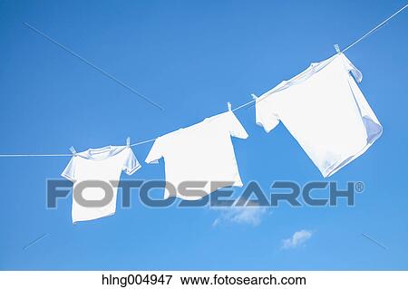 Stock Photo - Laundry hanging against blue sky. Fotosearch
