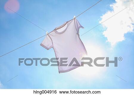 Stock Photograph - Laundry hanging against blue sky. Fotosearch