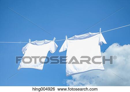 Laundry hanging against blue sky View Large Photo Image Stock Photograph - Laundry hanging against blue sky. Fotosearch