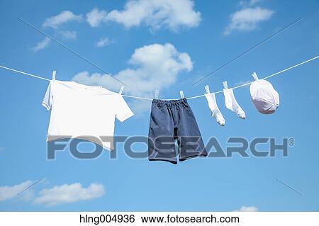 Laundry hanging against blue sky View Large Photo Image Stock Photograph - Laundry hanging against blue sky. Fotosearch