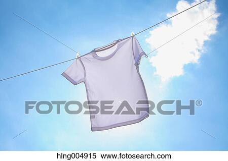 Laundry hanging against blue sky View Large Photo Image Stock Photography - Laundry hanging against blue sky. Fotosearch