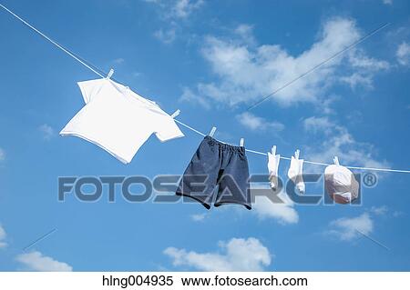 Laundry hanging against blue sky View Large Photo Image Stock Photography - Laundry hanging against blue sky. Fotosearch