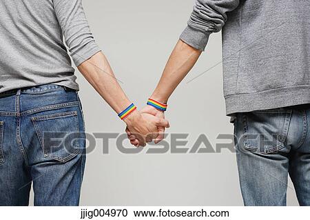 Male couple holding hands View Large Photo Image Stock Image - Male couple holding hands. Fotosearch
