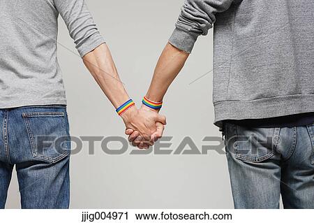 Male couple holding hands View Large Photo Image Stock Image - Male couple holding hands. Fotosearch