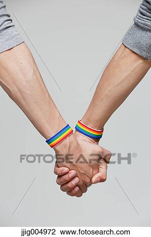 Male couple holding hands View Large Photo Image Stock Image - Male couple holding hands. Fotosearch