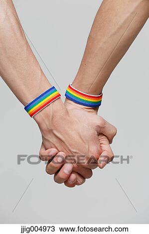Male couple holding hands View Large Photo Image Stock Image - Male couple holding hands. Fotosearch