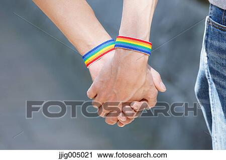 Male couple holding hands View Large Photo Image Stock Image - Male couple holding hands. Fotosearch