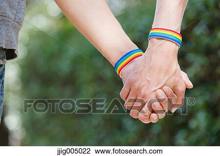 Stock Image - Male couple holding hands. Fotosearch