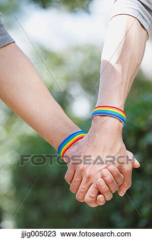 Male couple holding hands View Large Photo Image Stock Image - Male couple holding hands. Fotosearch