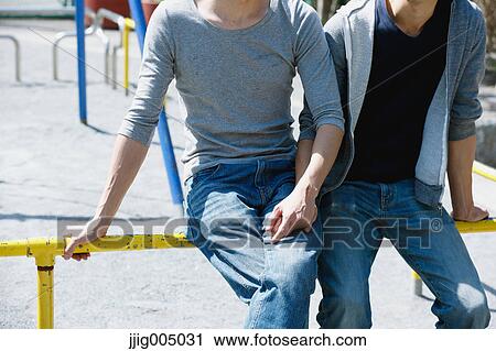 Stock Image - Male couple holding hands. Fotosearch