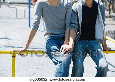 Stock Image - Male couple holding hands. Fotosearch
