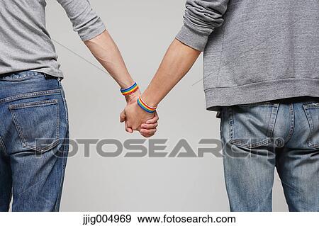 Male couple holding hands View Large Photo Image Stock Photo - Male couple holding hands. Fotosearch