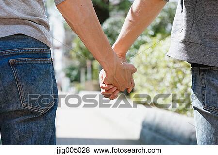 Male couple holding hands View Large Photo Image Stock Photo - Male couple holding hands. Fotosearch