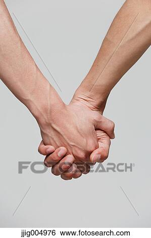 Male couple holding hands View Large Photo Image Stock Photograph - Male couple holding hands. Fotosearch