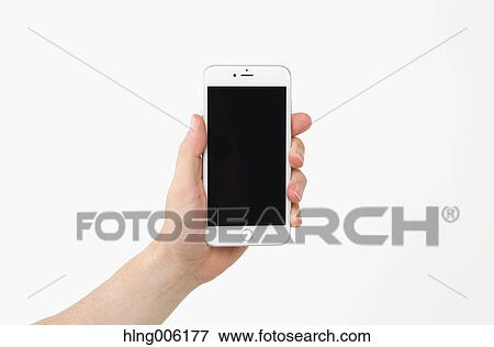 Male hand holding new type of smartphone View Large Photo Image Stock Photo - Male hand holding new type of smartphone. Fotosearch