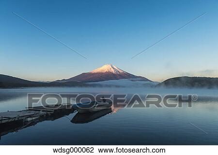 Stock Image - Morning light illuminating Mount Fuji at Lake Yamanaka, Yamanashi Prefecture, Japan. Fotosearch