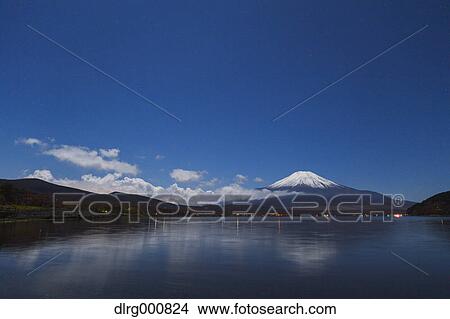Night view of cloudy sky and Mount Fuji at night from Lake Yamanaka, Yamanashi Prefecture, Japan View Large Photo Image Picture - Night view of cloudy sky and Mount Fuji at night from Lake Yamanaka, Yamanashi Prefecture, Japan. Fotosearch