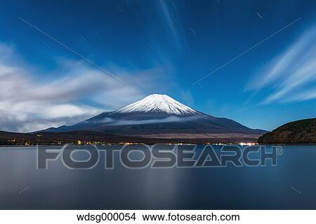 Night view of cloudy sky and Mount Fuji at night from Lake Yamanaka, Yamanashi Prefecture, Japan View Large Photo Image Picture - Night view of cloudy sky and Mount Fuji at night from Lake Yamanaka, Yamanashi Prefecture, Japan. Fotosearch