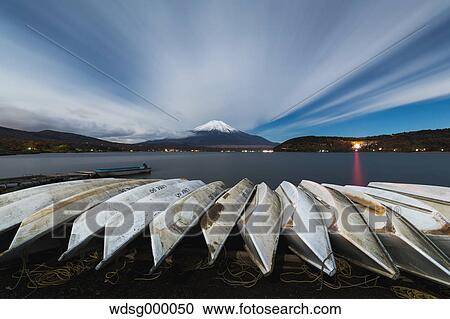 Night view of cloudy sky Mount Fuji and boats at Lake Yamanaka, Yamanashi Prefecture, Japan View Large Photo Image Stock Image - Night view of cloudy sky Mount Fuji and boats at Lake Yamanaka, Yamanashi Prefecture, Japan. Fotosearch