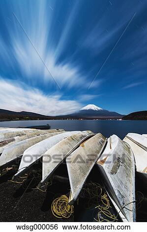 Night view of cloudy sky Mount Fuji and boats at Lake Yamanaka, Yamanashi Prefecture, Japan View Large Photo Image Stock Photograph - Night view of cloudy sky Mount Fuji and boats at Lake Yamanaka, Yamanashi Prefecture, Japan. Fotosearch