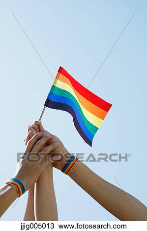 Stock Image - People with rainbow flags. Fotosearch