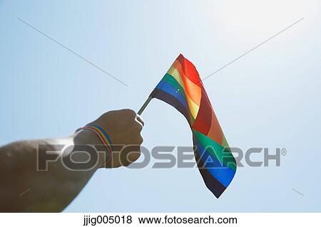 Stock Photo - People with rainbow flags. Fotosearch