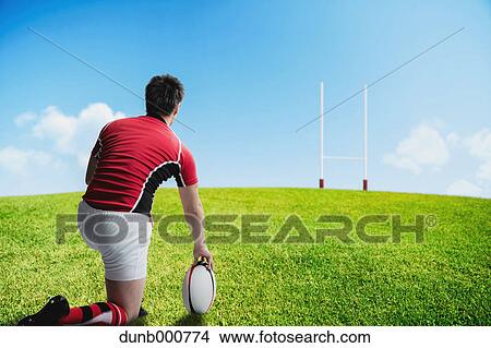 Portrait of Japanese rugby player preparing to kick the ball View Large Photo Image Picture - Portrait of Japanese rugby player preparing to kick the ball. Fotosearch