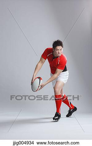 Portrait of Japanese rugby player throwing ball View Large Photo Image Picture - Portrait of Japanese rugby player throwing ball. Fotosearch