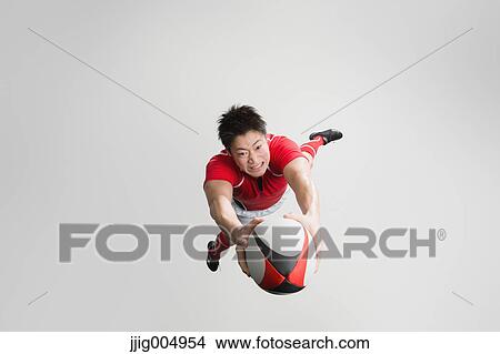 Portrait of Japanese rugby player diving to score a try View Large Photo Image Picture - Portrait of Japanese rugby player diving to score a try. Fotosearch