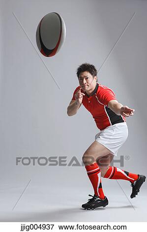 Portrait of Japanese rugby player throwing ball View Large Photo Image Stock Photo - Portrait of Japanese rugby player throwing ball. Fotosearch