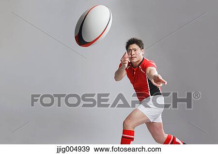 Portrait of Japanese rugby player throwing ball View Large Photo Image Stock Photo - Portrait of Japanese rugby player throwing ball. Fotosearch