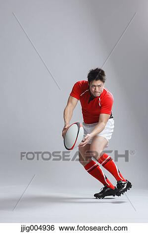 Portrait of Japanese rugby player throwing ball View Large Photo Image Stock Photograph - Portrait of Japanese rugby player throwing ball. Fotosearch