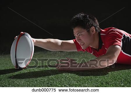 Portrait of Japanese rugby player diving to score a try View Large Photo Image Stock Photography - Portrait of Japanese rugby player diving to score a try. Fotosearch