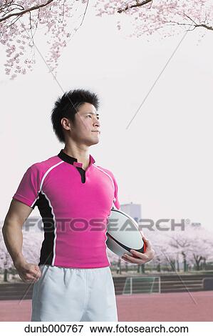 Portrait of Japanese rugby player with ball View Large Photo Image Stock Photo - Portrait of Japanese rugby player with ball. Fotosearch