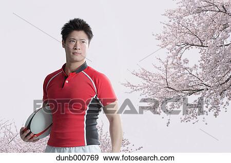 Portrait of Japanese rugby player with ball View Large Photo Image Stock Photo - Portrait of Japanese rugby player with ball. Fotosearch