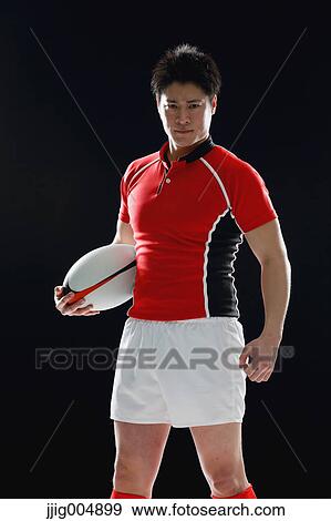 Portrait of Japanese rugby player with ball View Large Photo Image Stock Photo - Portrait of Japanese rugby player with ball. Fotosearch