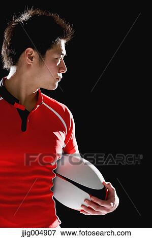 Portrait of Japanese rugby player with ball View Large Photo Image Stock Photo - Portrait of Japanese rugby player with ball. Fotosearch