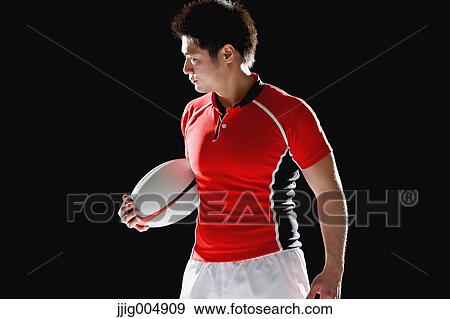 Stock Photo - Portrait of Japanese rugby player with ball. Fotosearch
