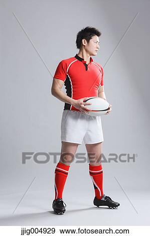 Portrait of Japanese rugby player with ball View Large Photo Image Stock Photo - Portrait of Japanese rugby player with ball. Fotosearch