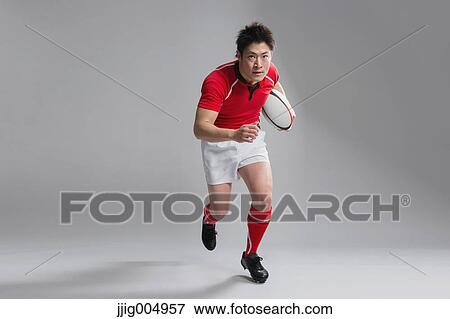 Portrait of Japanese rugby player with ball View Large Photo Image Stock Photo - Portrait of Japanese rugby player with ball. Fotosearch