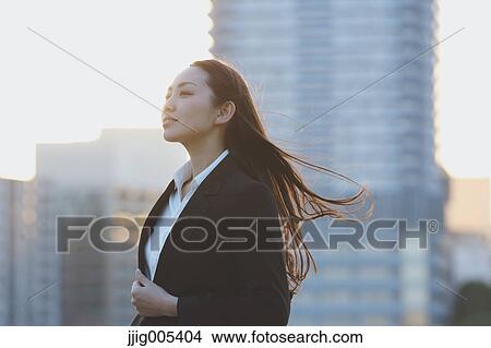 Portrait of young Japanese businesswoman by a river downtown Tokyo View Large Photo Image Picture - Portrait of young Japanese businesswoman by a river downtown Tokyo. Fotosearch