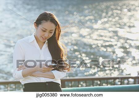 Portrait of young Japanese businesswoman by a river downtown Tokyo View Large Photo Image Stock Image - Portrait of young Japanese businesswoman by a river downtown Tokyo. Fotosearch